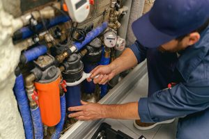 professional-plumber-repairing-water-supply-system-QEDHLWP.jpg